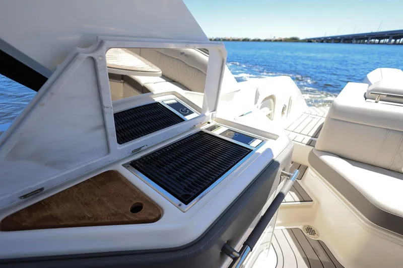 Slide: The Image of Luxury Sea Ray SLX 310 Outboard boat with onboard grill, 2023 model, on a sunny day. - 28