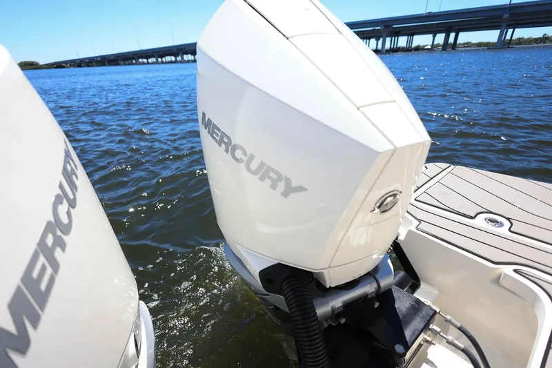 Slide: The Image of 2023 Sea Ray SLX 310 Outboard with Mercury engines on water near bridge. - 35