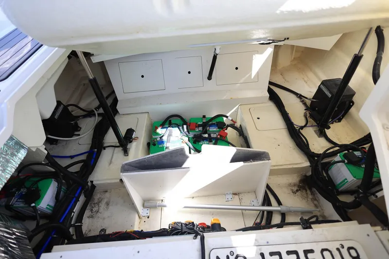 Slide: The Image of 2023 Sea Ray SLX 310 Outboard engine compartment with visible wiring and components. - 37