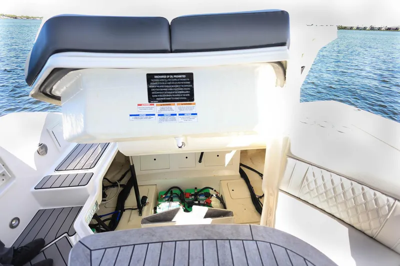 Slide: The Image of 2023 Sea Ray SLX 310 Outboard boat storage compartment with open hatch, on water. - 38