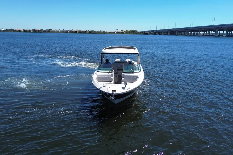 Slide: The Image of 2023 Sea Ray SLX 310 Outboard cruising on a sunny day near a bridge. - 4