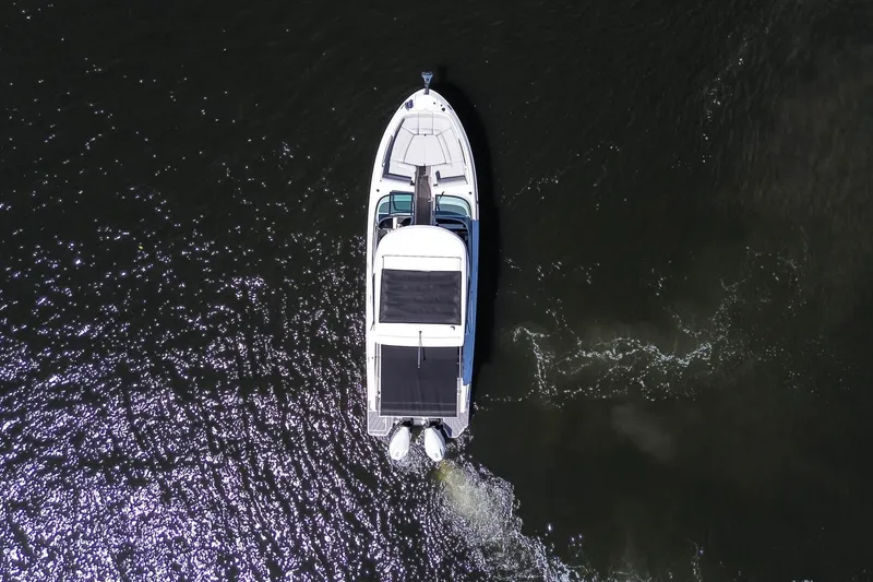 Slide: The Image of Aerial view of 2023 Sea Ray SLX 310 Outboard cruising on water. - 5