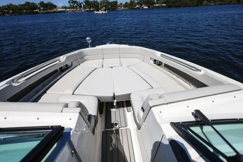 Slide: The Image of 2023 Sea Ray SLX 310 Outboard boat interior with luxurious seating on a calm lake. - 6