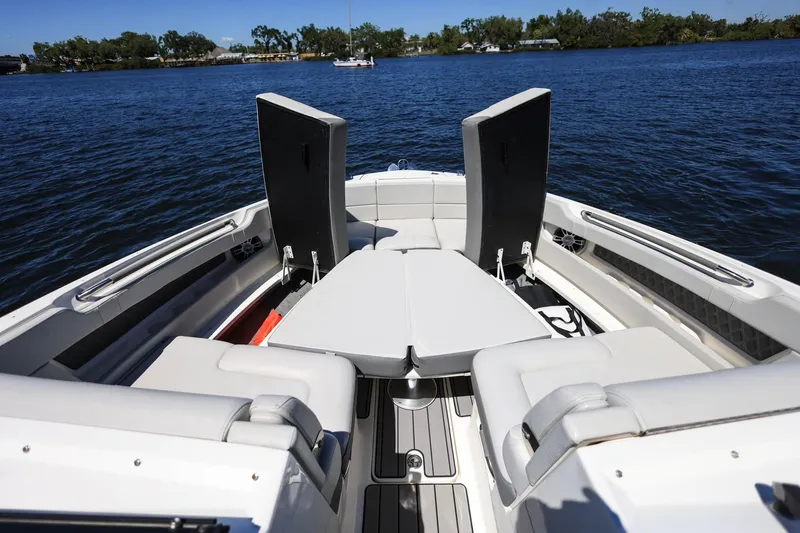 Slide: The Image of 2023 Sea Ray SLX 310 Outboard boat interior with seating, on a calm lake. - 7