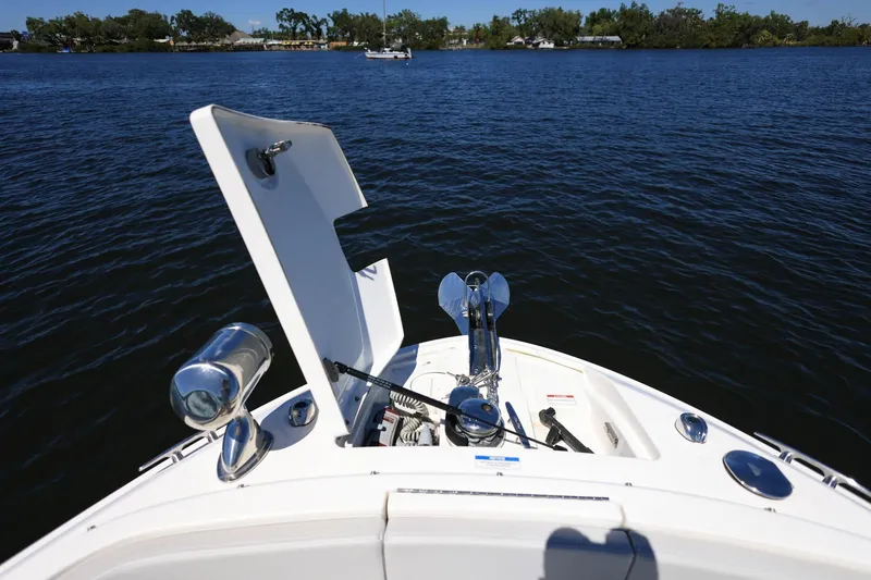 Slide: The Image of 2023 Sea Ray SLX 310 Outboard boat with open anchor hatch on calm water. - 8