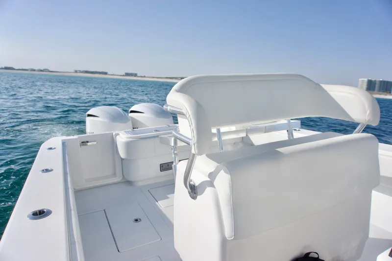 Slide: The Image of 2021 Contender 32 ST boat on water, featuring dual engines and sleek white seating. - 10