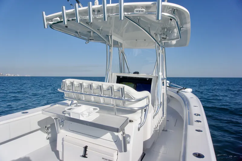 Slide: The Image of 2021 Contender 32 ST boat on open sea, featuring sleek design and fishing rod holders. - 11