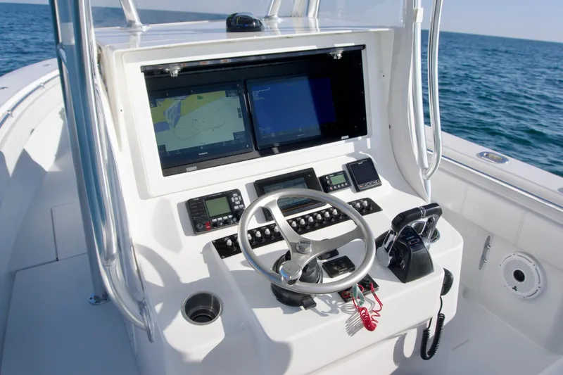 Slide: The Image of Center console of 2021 Contender 32 ST boat with navigation screens and controls. - 13