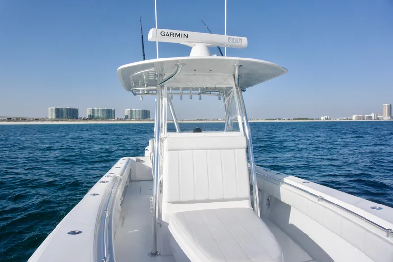 Slide: The Image of 2021 Contender 32 ST boat on open water with coastal skyline in background. - 14