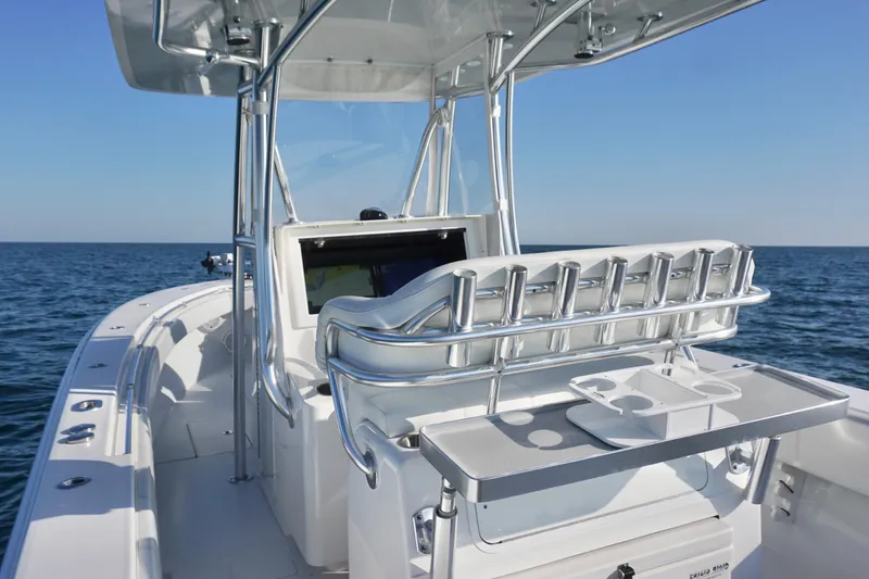 Slide: The Image of 2021 Contender 32 ST boat on open water, featuring sleek design and modern console. - 16