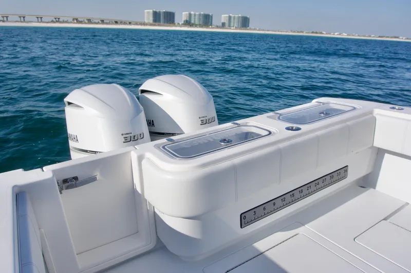 Slide: The Image of 2021 Contender 32 ST boat with twin Yamaha 300 engines on open water. - 17