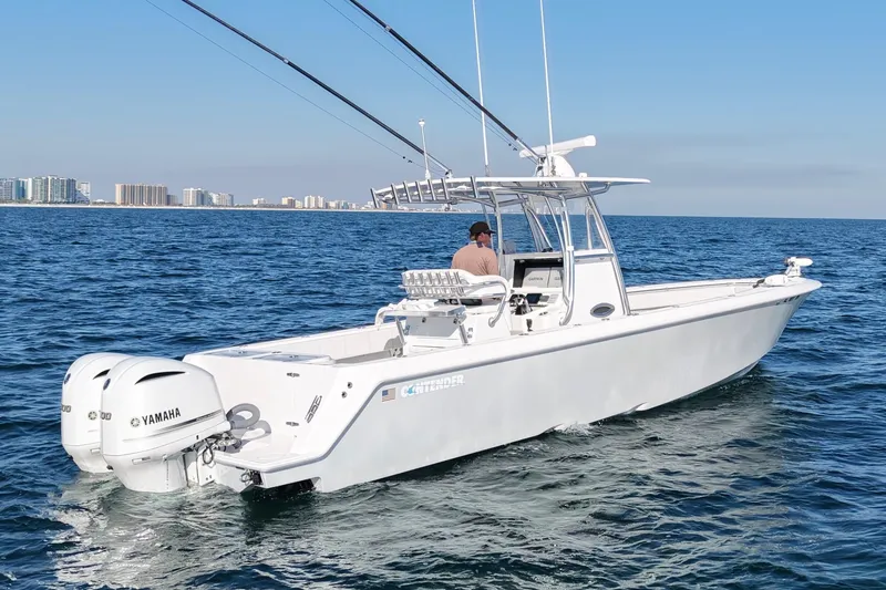 Slide: The Image of 2021 Contender 32 ST boat on open water with city skyline in background. - 4