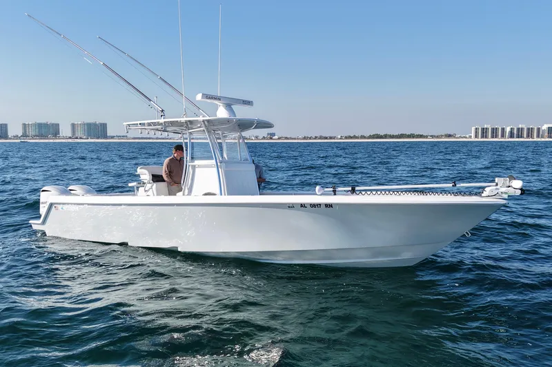 Slide: The Image of 2021 Contender 32 ST boat on open water, featuring fishing rods and modern design. - 5