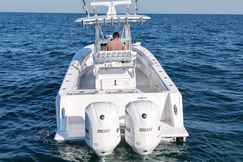 Slide: The Image of 2021 Contender 32 ST boat with dual Yamaha 300 engines on open water. - 6