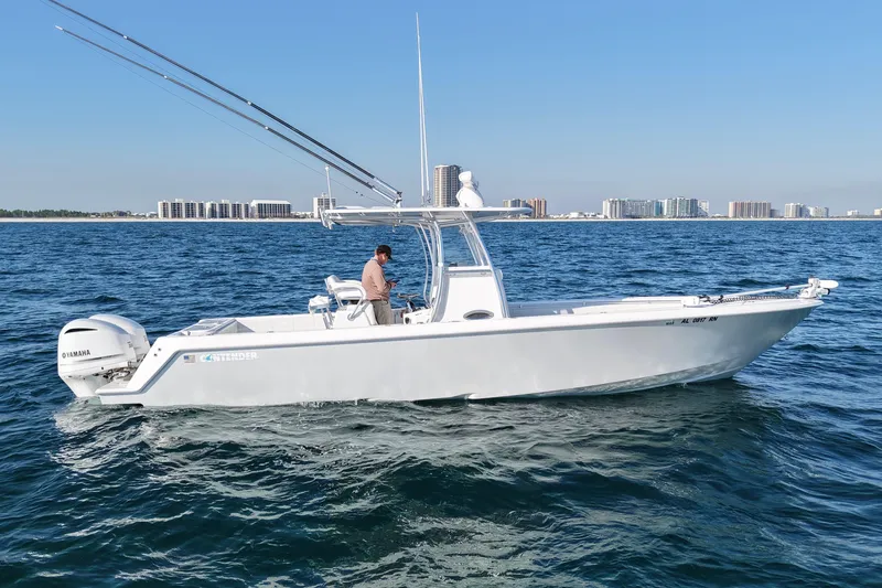 Slide: The Image of 2021 Contender 32 ST boat cruising on open water with city skyline in background. - 8