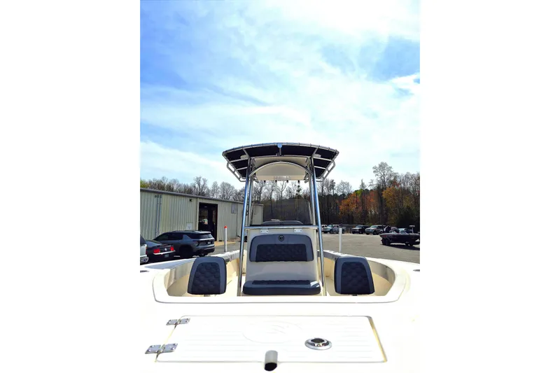 Slide: The Image of 2026 May-Craft 245 Offshore CC boat with T-top, parked outdoors. - 10