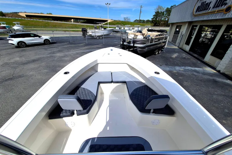 Slide: The Image of 2026 May-Craft 245 Offshore CC boat with spacious seating, displayed at a dealership. - 11