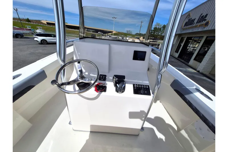 Slide: The Image of 2026 May-Craft 245 Offshore CC boat console with steering wheel and controls. - 15