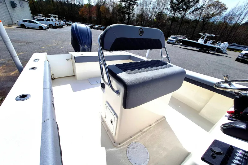 Slide: The Image of 2026 May-Craft 245 Offshore CC boat interior with seating and steering wheel. - 16