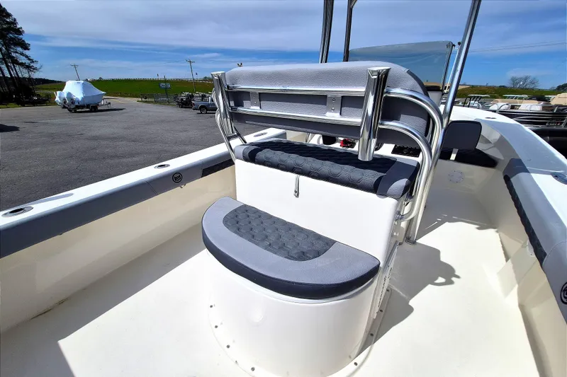 Slide: The Image of 2026 May-Craft 245 Offshore CC boat interior with cushioned seating and stainless steel railings. - 17