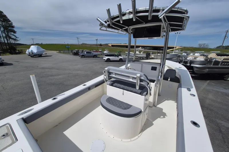 Slide: The Image of 2026 May-Craft 245 Offshore CC boat with center console and seating, parked outdoors. - 19
