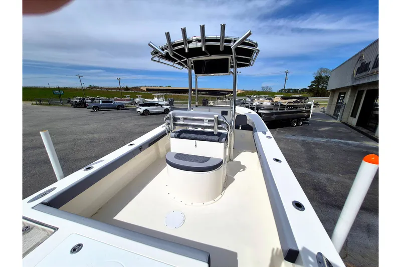 Slide: The Image of 2026 May-Craft 245 Offshore CC boat with center console and T-top in a parking lot. - 22
