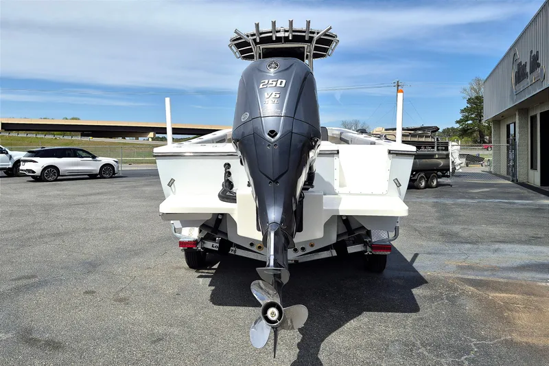 Slide: The Image of 2026 May-Craft 245 Offshore CC boat with powerful outboard motor in a parking lot. - 4