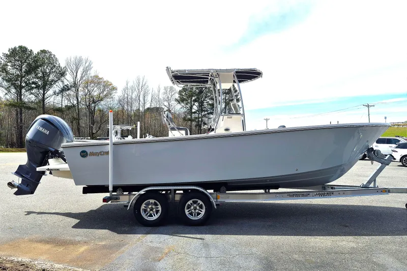 Slide: The Image of 2026 May-Craft 245 Offshore CC boat on trailer with Yamaha engine, parked outdoors. - 7