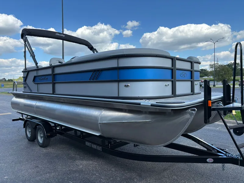 Slide: The Image of 2027 Bentley Pontoons 223 Bolt on trailer, blue sky. - 3