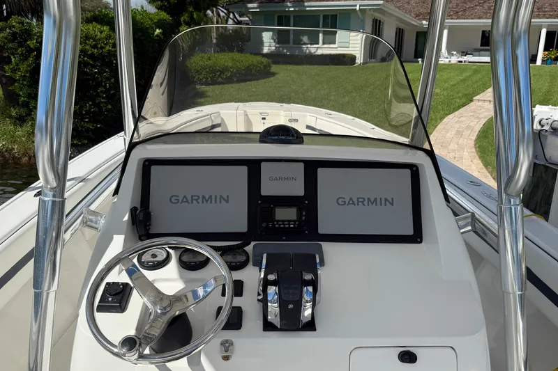 Slide: The Image of 2009 Intrepid 323 Open boat dashboard with Garmin navigation displays. - 13