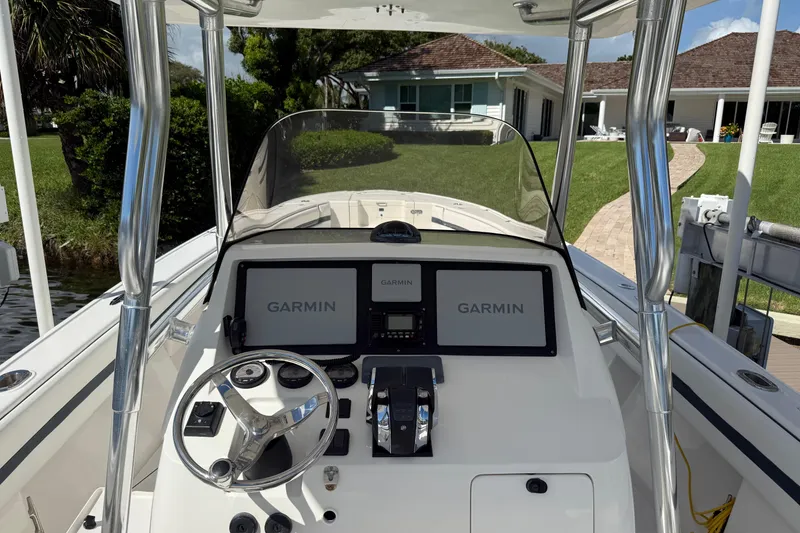Slide: The Image of 2009 Intrepid 323 Open boat dashboard with Garmin navigation system and steering wheel. - 15