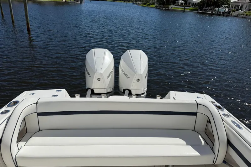 Slide: The Image of 2009 Intrepid 323 Open boat with twin Mercury engines on a calm waterway. - 3