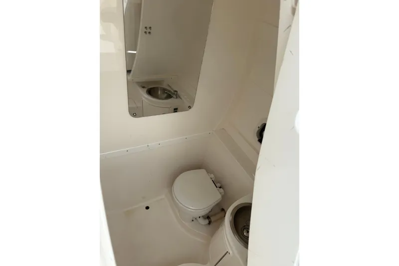 Slide: The Image of Compact bathroom in 2009 Intrepid 323 Open boat with toilet and sink. - 5