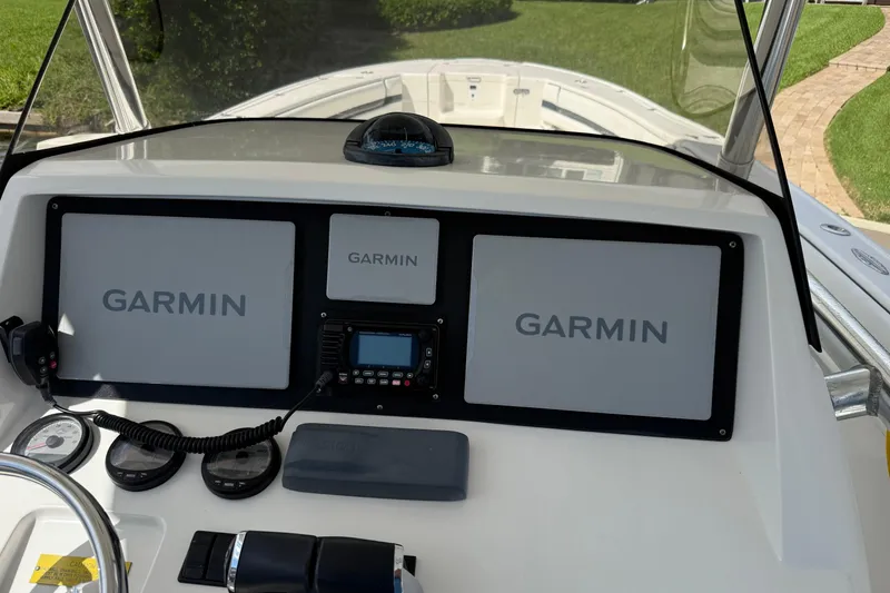 Slide: The Image of 2009 Intrepid 323 Open boat dashboard with Garmin navigation displays. - 6