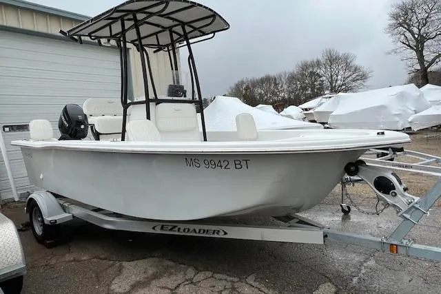 The Image of Savannah SS19 2021 boat on EZ Loader trailer, parked outdoors near storage facility. - 1