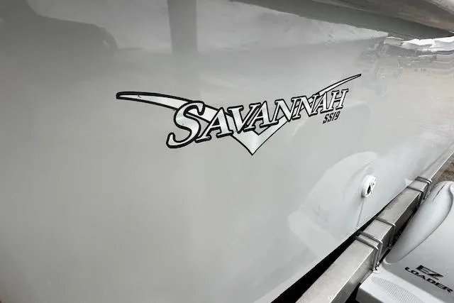 Slide: The Image of Savannah SS19 boat logo on sleek gray surface, 2021 model. - 10