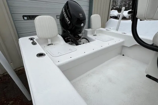 Slide: The Image of 2021 Savannah SS19 boat interior with Suzuki outboard motor, white seating, and storage compartments. - 11