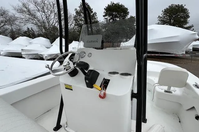 Slide: The Image of 2021 Savannah SS19 boat console with steering wheel and Garmin navigation system. - 13