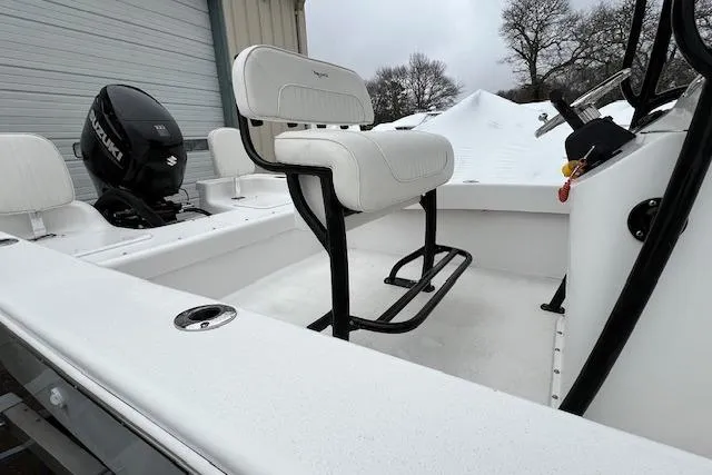 Slide: The Image of White 2021 Savannah SS19 boat interior with seating and Suzuki outboard motor. - 14