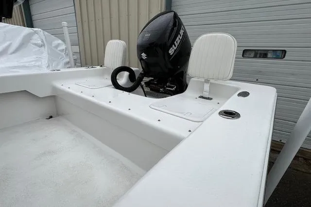Slide: The Image of 2021 Savannah SS19 boat with Suzuki outboard motor, white interior, and storage compartments. - 3