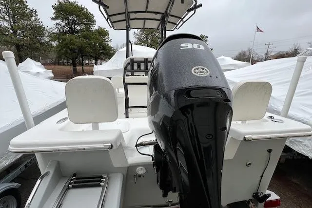 Slide: The Image of 2021 Savannah SS19 boat with 90 HP engine, rear view, parked outdoors. - 7