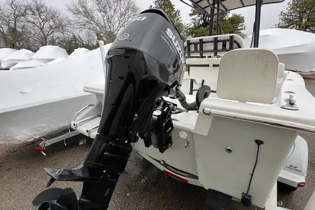 Slide: The Image of 2021 Savannah SS19 boat with Suzuki outboard motor, parked outdoors. - 9