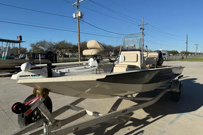 Slide: The Image of 2016 Xpress H20B Bay boat on trailer, featuring Minn Kota trolling motor. - 3