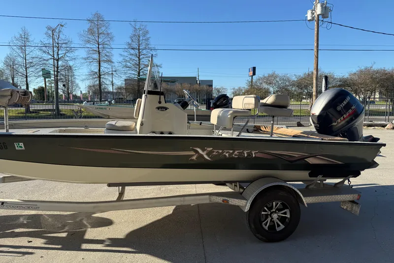 Slide: The Image of 2016 Xpress H20B Bay boat on trailer with Yamaha outboard motor. - 4