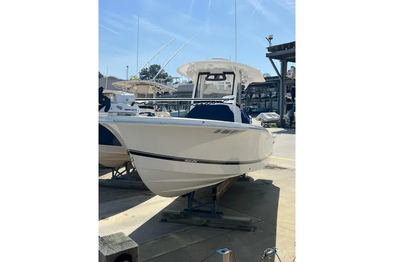 Slide: The Image of 2023 Regulator 26XO boat displayed in a marina setting. - 10