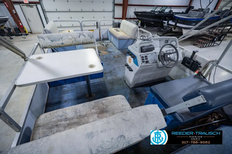 Slide: The Image of Interior of a 1993 Godfrey SW 180 boat with seating and control panel. - 15