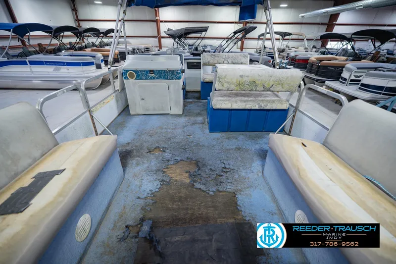 Slide: The Image of Interior of a 1993 Godfrey SW 180 boat with worn seating and flooring. - 16