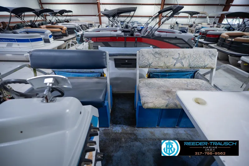 Slide: The Image of Interior of a 1993 Godfrey SW 180 boat with seating and steering wheel. - 18