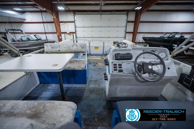 Slide: The Image of Interior of a 1993 Godfrey SW 180 boat with seating and control panel. - 19