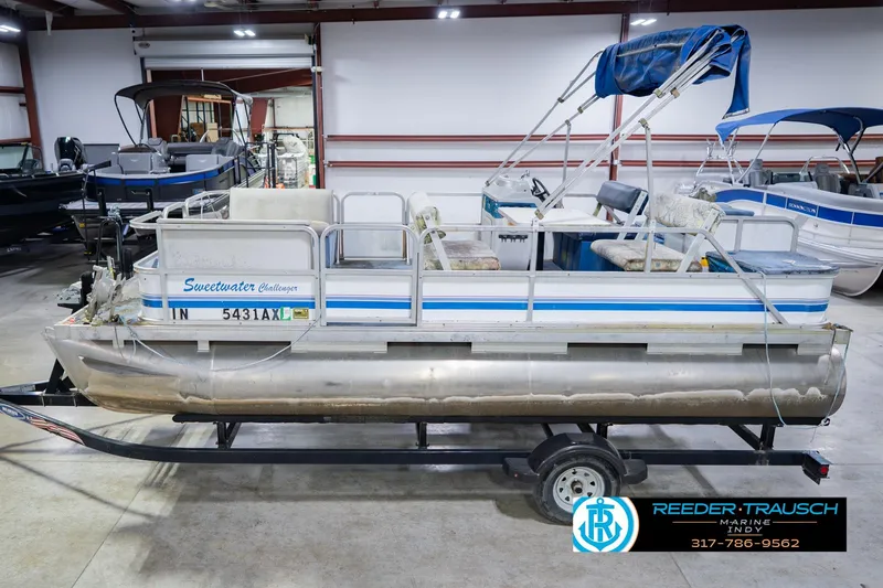The Image of 1993 Godfrey SW 180 pontoon boat in showroom, featuring Sweetwater Challenger branding. - 2